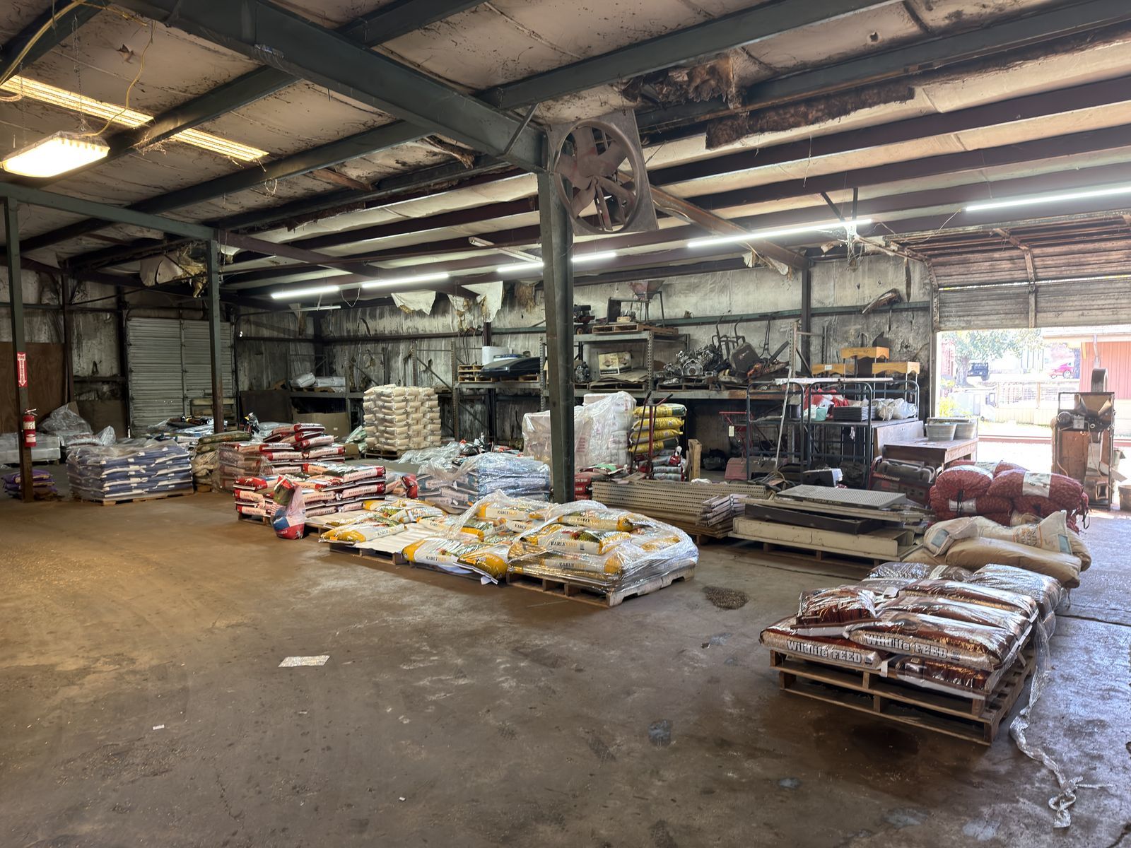 Pallets of bagged wildlife feed and farm supplies in the Feeders Milling warehouse